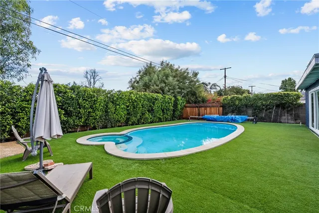 a view of kitchen with stainless steel appliances granite countertop a refrigerator sink and cabinets