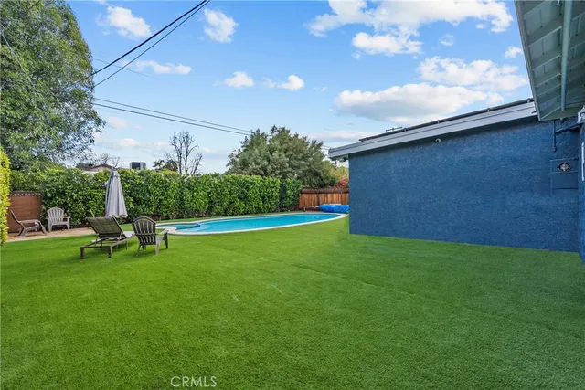 a view of kitchen with wooden floor and electronic appliances