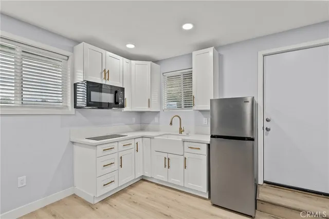 a view of house with yard street and trees in the background