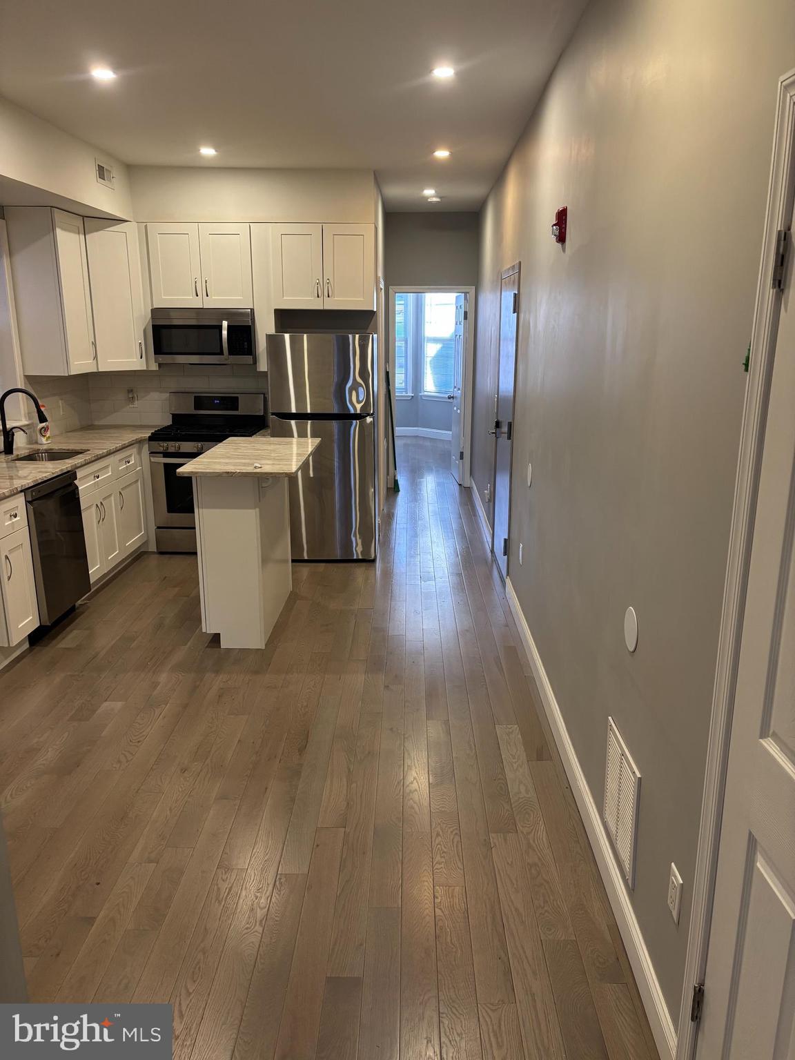 216 Buckingham Place, Unit 2 Philadelphia, PA 19104 - Photo 4 of 18 a kitchen with a refrigerator and a stove top oven