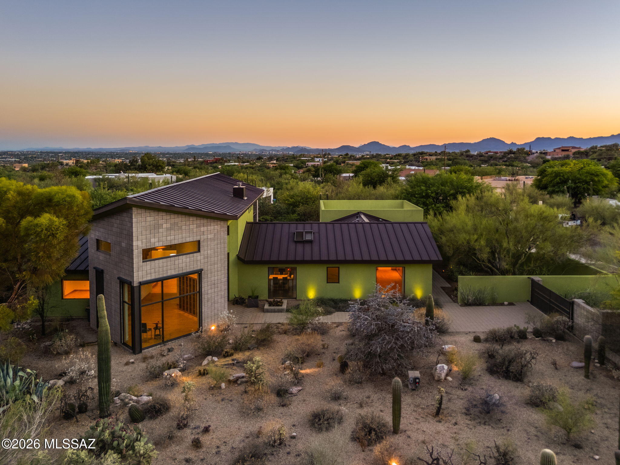 5070 North Valley View Road Tucson, AZ 85718 - Photo 5 of 51 a view of a house with a yard and table under an umbrella