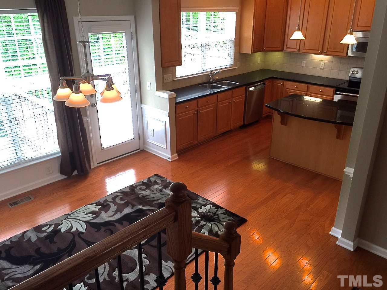 2742 Laurel Cherry Street Raleigh, NC 27612 - Photo 11 of 25 This is the view from the stairs overlooking the dining room and the kitchen at the back of the home.