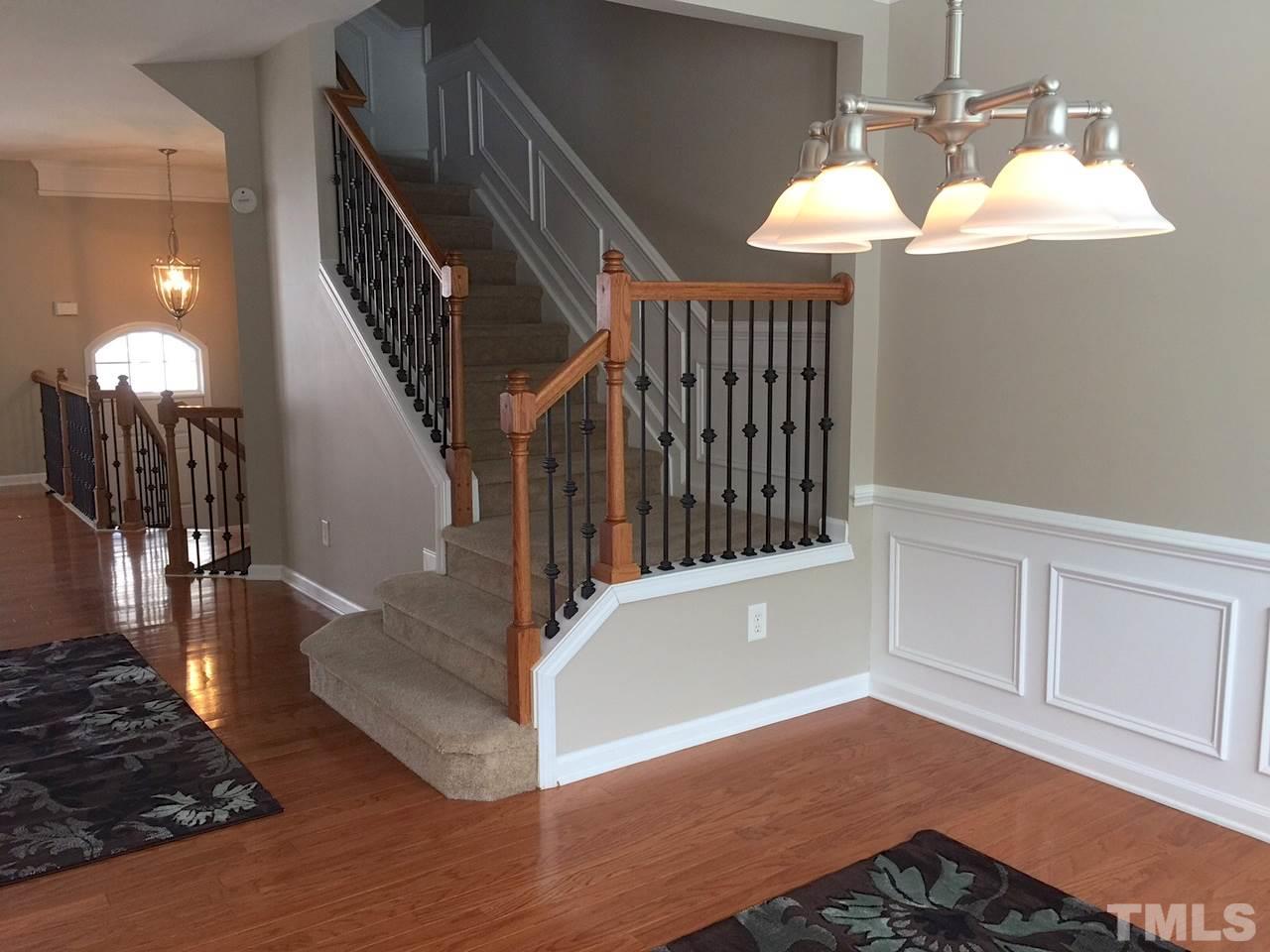 2742 Laurel Cherry Street Raleigh, NC 27612 - Photo 12 of 25 Notice the wainscoting and how nice it looks with the color of the hardwoods and the wall color.