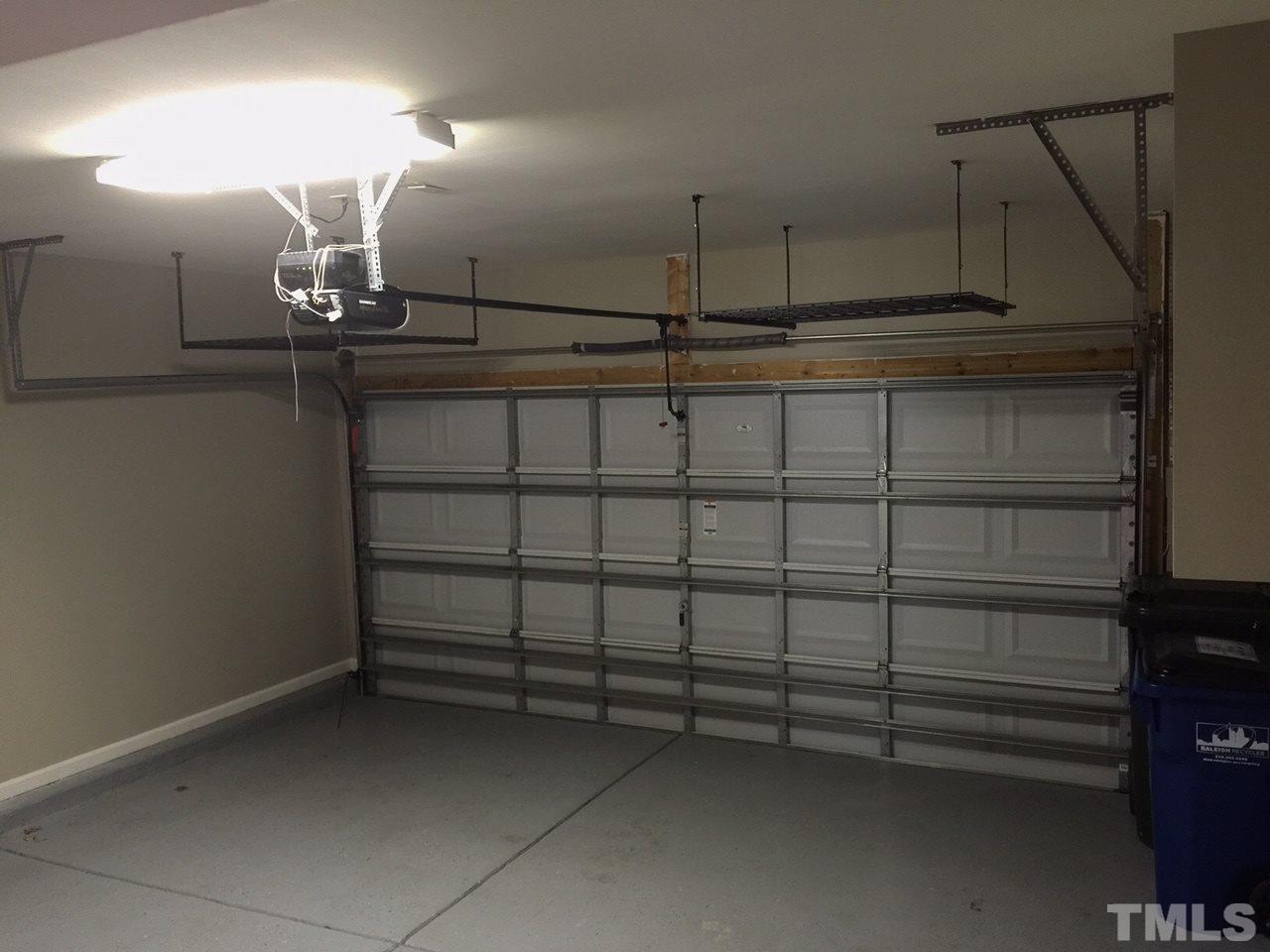 2742 Laurel Cherry Street Raleigh, NC 27612 - Photo 23 of 25 A large two car garage with additional storage areas above the garage door, under the stairs and in an under stairs closet.