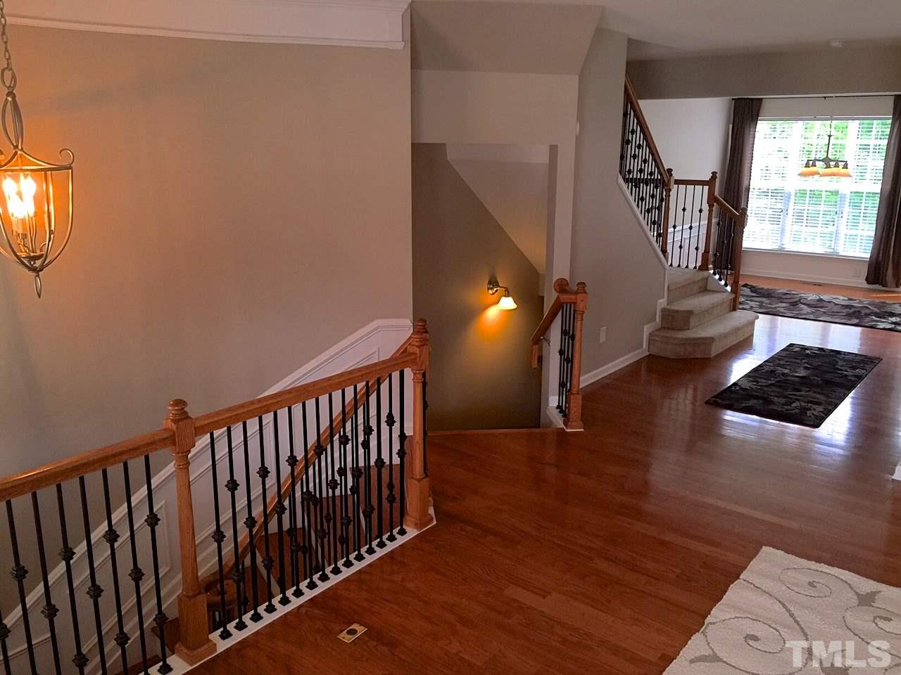 2742 Laurel Cherry Street Raleigh, NC 27612 - Photo 8 of 25 Viewed from the living room to the back of the house and the Dining Room. The iron balusters are a nice accent to the stairs. Another nice upgrade in this home.