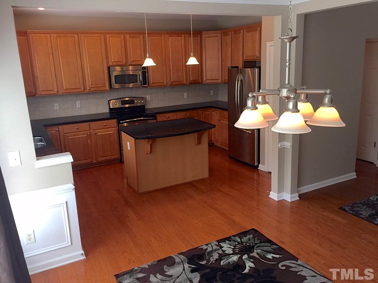 2742 Laurel Cherry Street Raleigh, NC 27612 - Photo 10 of 25 The kitchen has granite counters, stainless steel appliances, tile back splash and under cabinet lighting. There's plenty of raised panel cabinets and storage in the island and pantry.