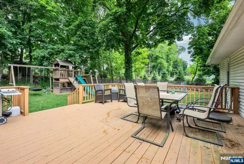 a view of a chairs and table on the wooden deck