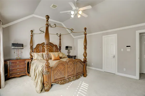 a bedroom with a bed dresser and a window