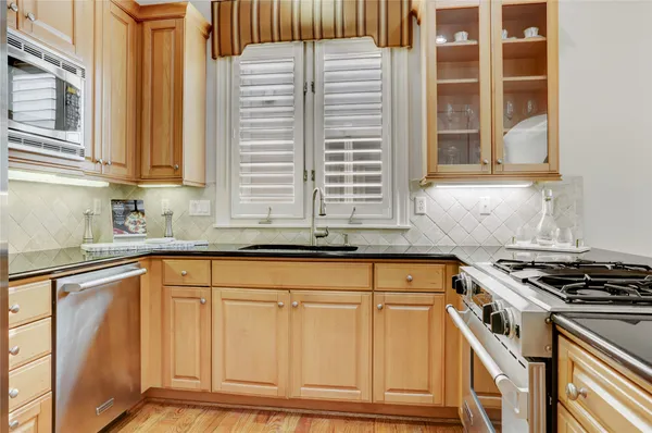a kitchen with granite countertop a sink and cabinets