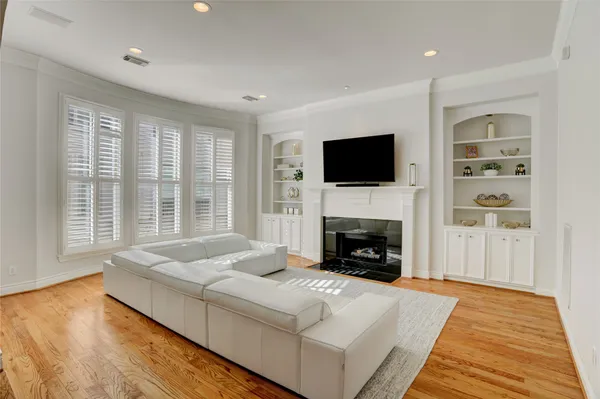 a living room with fireplace furniture and a flat screen tv