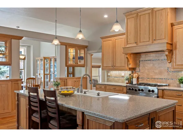 a kitchen with a table chairs and cabinets