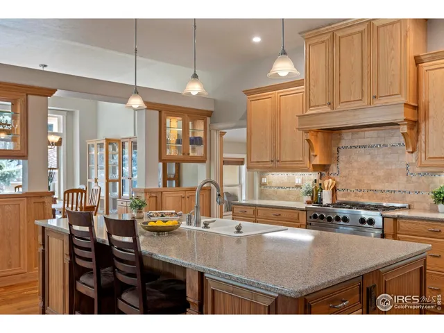 a kitchen with a table chairs and cabinets