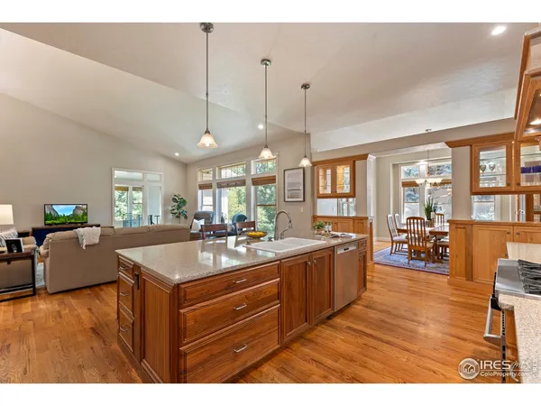 a kitchen with sink and view of living room