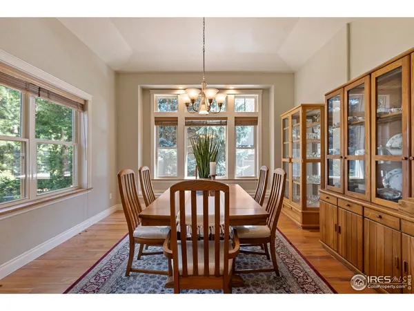 a view of a dining room with furniture large windows and wooden floor