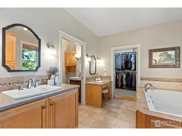 a bathroom with a sink double vanity and a tub