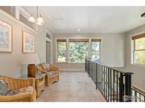 a living room with furniture and large windows