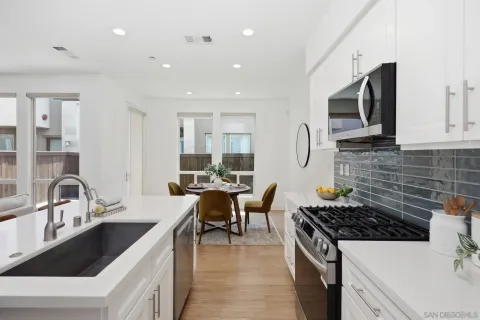 a kitchen with stainless steel appliances a sink stove and microwave