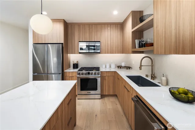 a kitchen with a sink appliances and cabinets