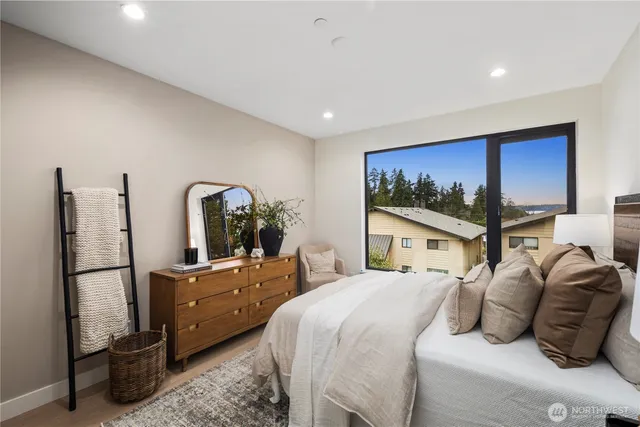 a bedroom with a bed and a painting on the wall