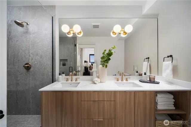 a bathroom with a sink double vanity and a mirror
