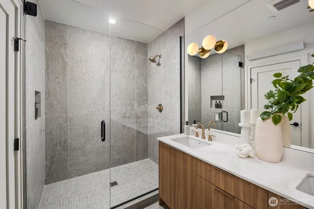 a bathroom with a sink a mirror and a shower