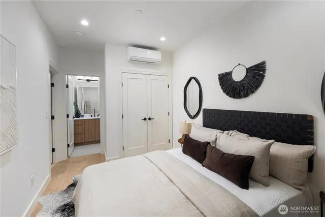 a bedroom with bed and cabinets