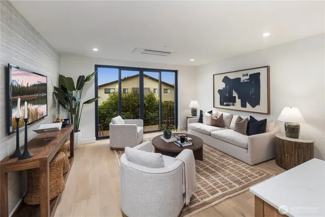 a living room with furniture large window and a flat screen tv