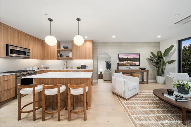 a large kitchen with kitchen island a dining table and a chandelier