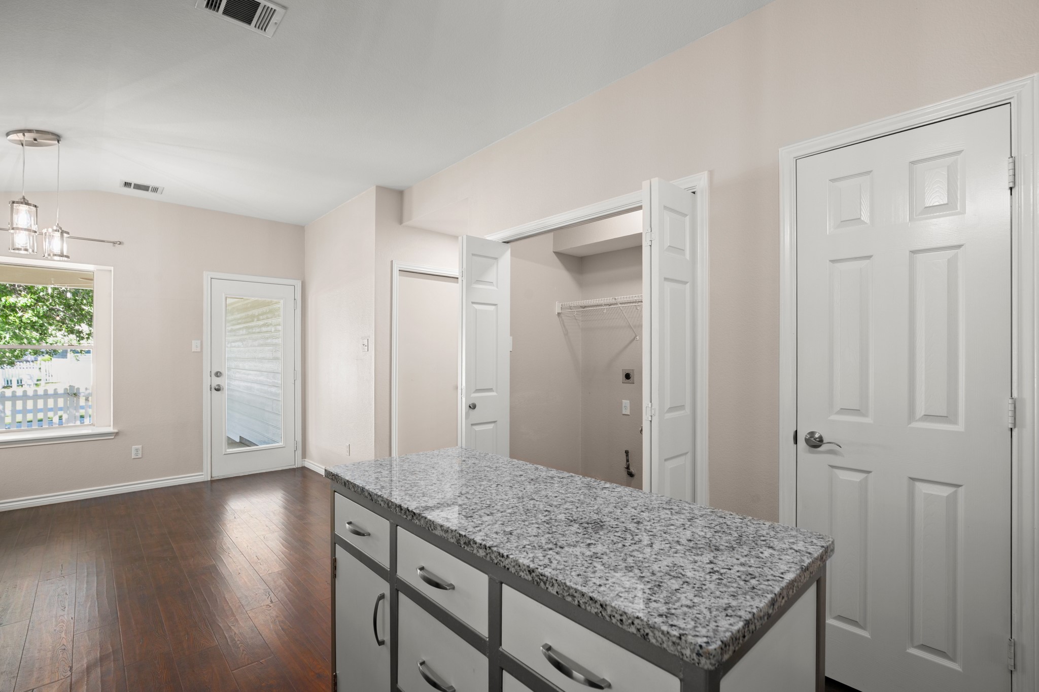 151 Sampson Kyle, TX 78640 - Photo 18 of 23 The kitchen island anchors the whole space beautifully, giving the layout an easy flow that works whether you’re cooking dinner or hosting.