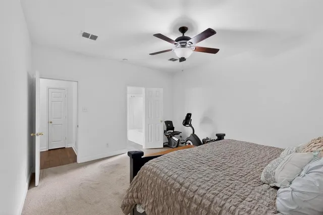 a bed room with a bed and a chandelier