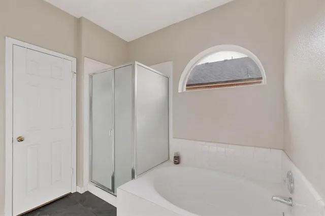 a white bath tub sitting next to a shower