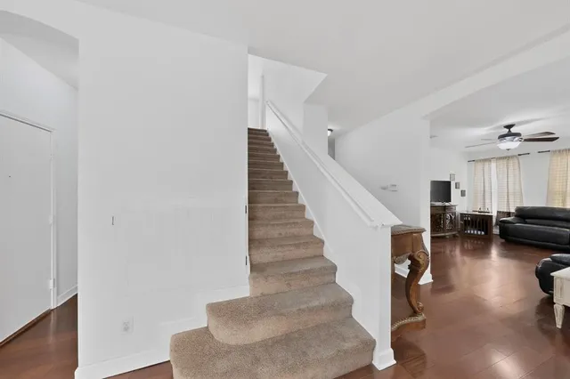 a view of entryway and hall with wooden floor