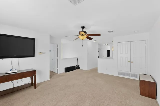 a view of a livingroom with furniture and a flat screen tv