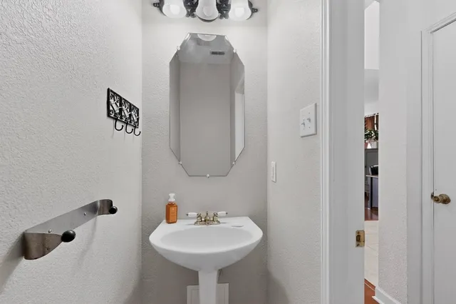 a bathroom with a sink and mirror