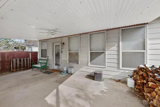 a backyard of a house with table and chairs