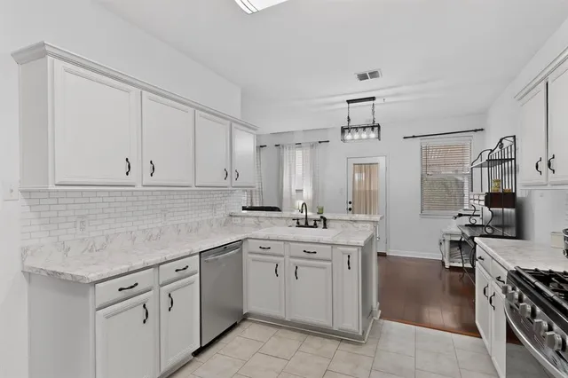a kitchen with a sink and cabinets