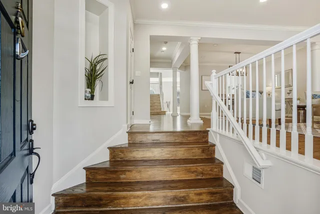a view of staircase with white walls and a window