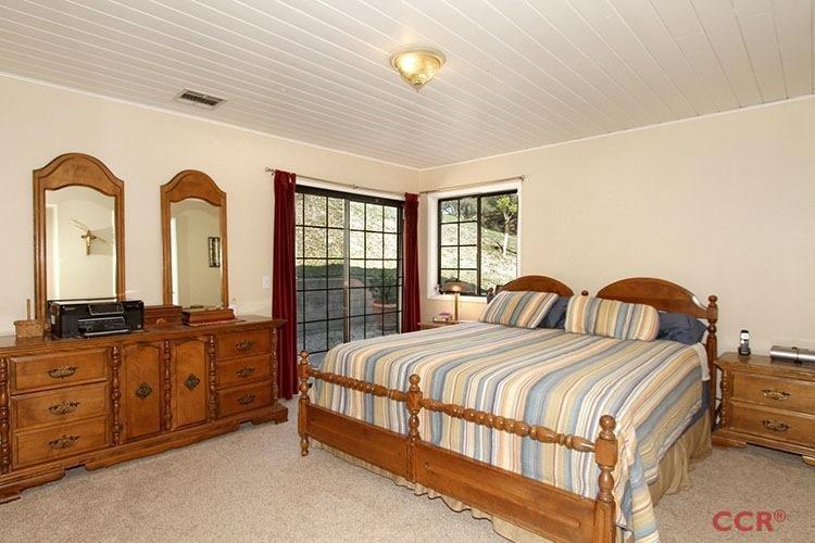 5307 Cascabel Road Atascadero, CA 93422 - Photo 14 of 25 a bedroom with a bed and a dresser