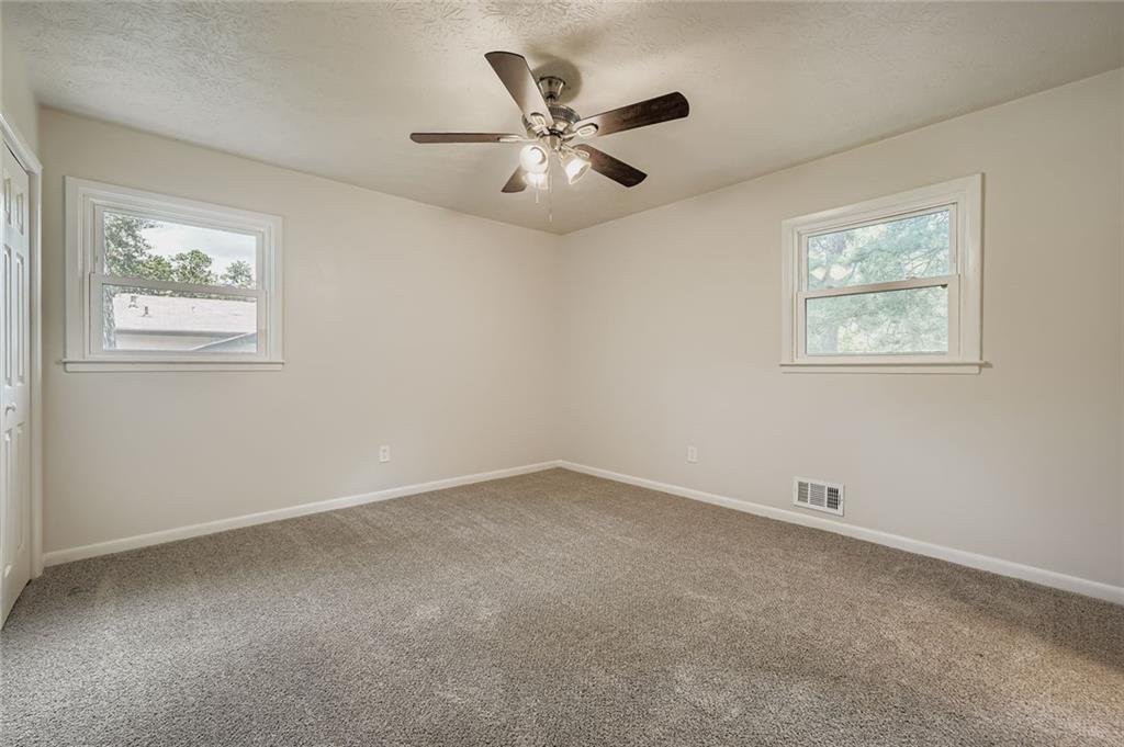 6678 Collier Way Riverdale, GA 30296 - Photo 16 of 29 an empty room with a window and a ceiling fan
