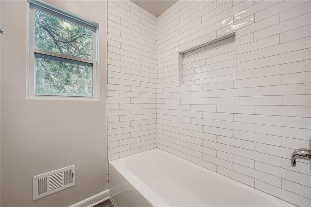 6678 Collier Way Riverdale, GA 30296 - Photo 23 of 29 a bathroom with a bathtub