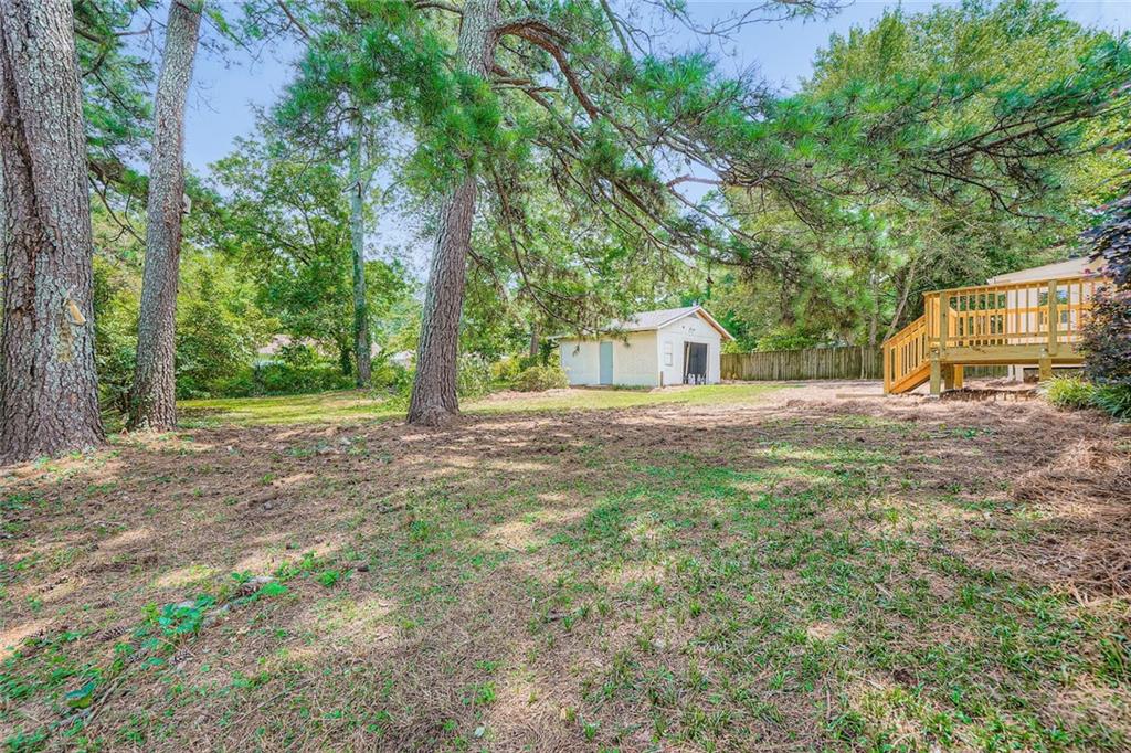 6678 Collier Way Riverdale, GA 30296 - Photo 27 of 29 a view of a house with backyard and trees