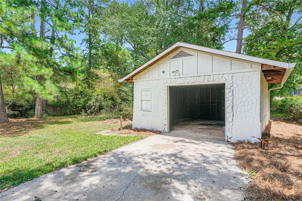 6678 Collier Way Riverdale, GA 30296 - Photo 29 of 29 a view of a small yard in front of a house with a large tree