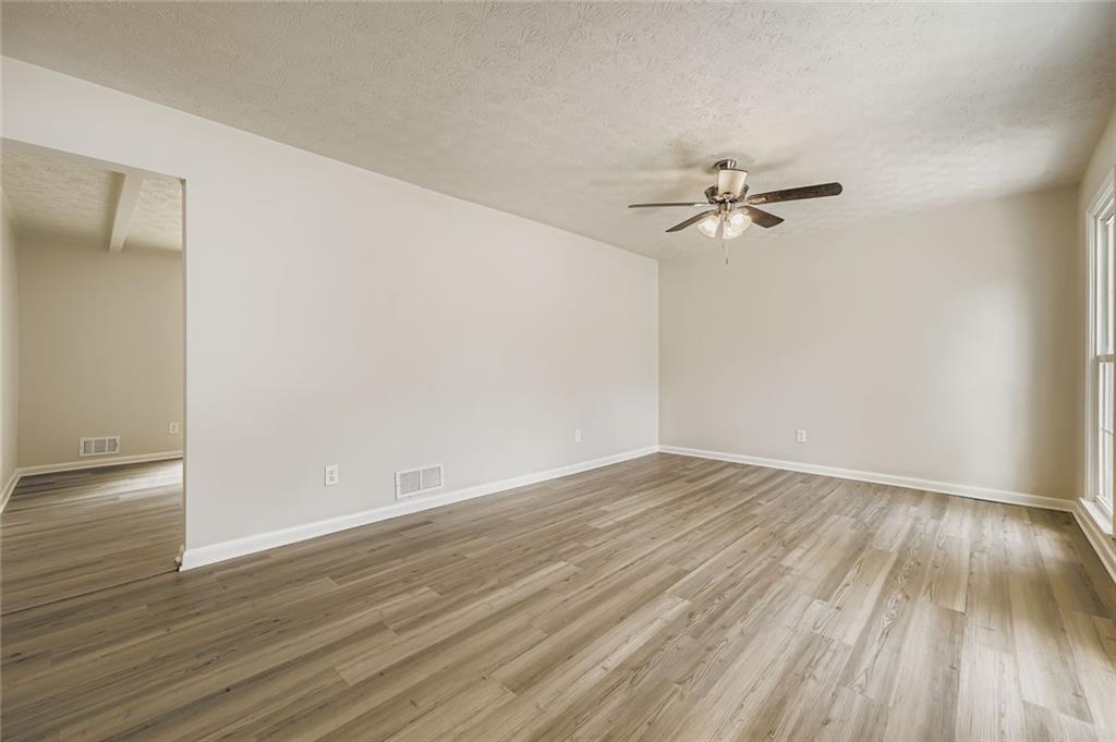 6678 Collier Way Riverdale, GA 30296 - Photo 5 of 29 a view of an empty room with wooden floor