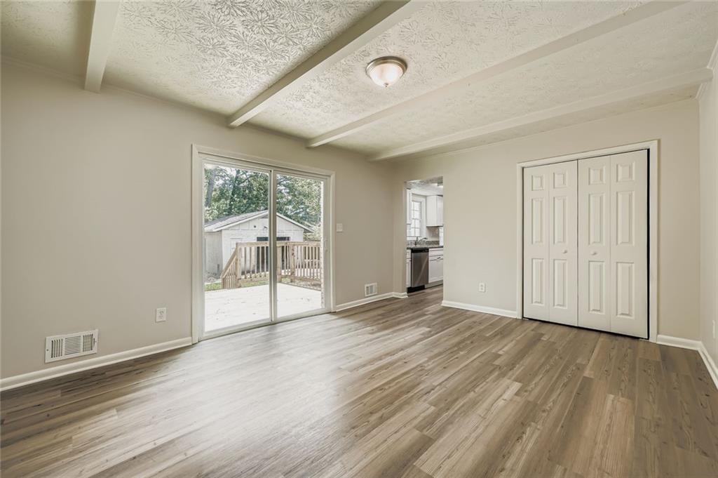 6678 Collier Way Riverdale, GA 30296 - Photo 8 of 29 wooden floor in an empty room with a window