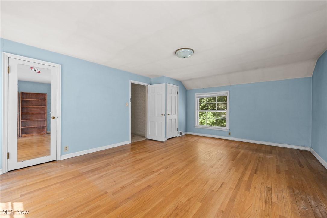 1525 Kew Road Cleveland, OH 44118 - Photo 25 of 31 Unfurnished bedroom with light wood-style floors and vaulted ceiling