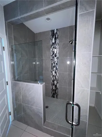 a bathroom with a glass shower door