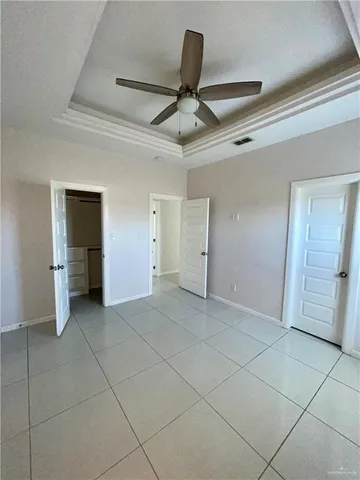 a view of an empty room with a ceiling fan