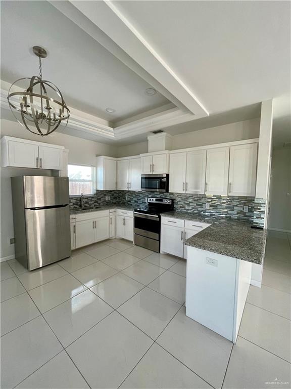 404 Rafael Drive, Unit 1 San Juan, TX 78589 - Photo 4 of 16 a kitchen with stainless steel appliances granite countertop a refrigerator and a sink
