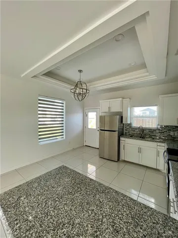 a large kitchen with a stove a sink dishwasher and a refrigerator