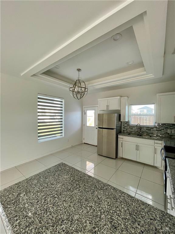 404 Rafael Drive, Unit 1 San Juan, TX 78589 - Photo 5 of 16 a large kitchen with a stove a sink dishwasher and a refrigerator